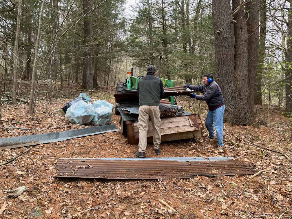 Volunteers cleaning up junk with tractor